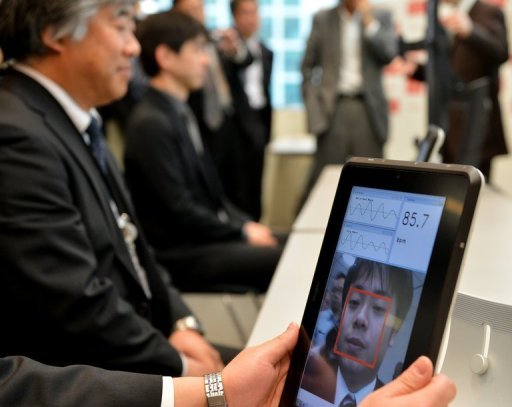 A Fujitsu engineer demonstrates how a smartphone that can take the pulse of a user just by looking at his or her face works