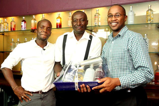 Kingkline Ojal received an ABSOLUT hamper from Brian Owango and TOm Njeru Events and Promotions Manager - Pernod Ricard