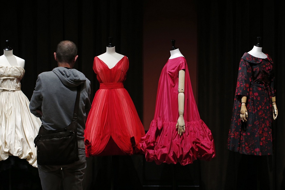A visitor looks at vintage dresses by designers Balenciaga, Jean Desses and Christian Dior presented in the exhibition "Les Annees 50, La mode en France" at the Palais Galliera  fashion museum in Paris