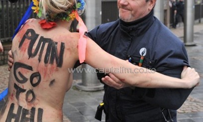 A Femen activist demonstrates against Russian President Vladimir Putin/AFP
