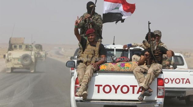 Iraqi volunteer fighters drive towards the town of Amerli, eastern Iraq on September 1, 2014/AFP