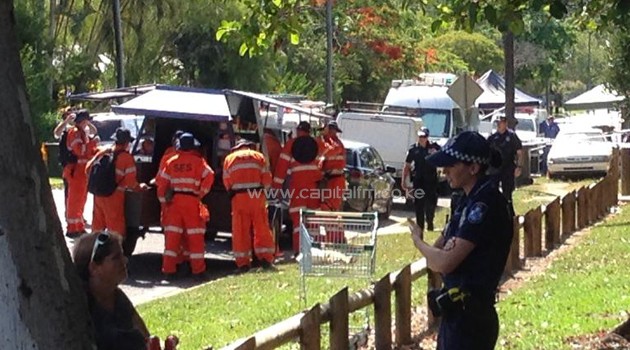 Police gather outside a house where eight children ranging from babies to teenagers were found dead in Australia/AFP