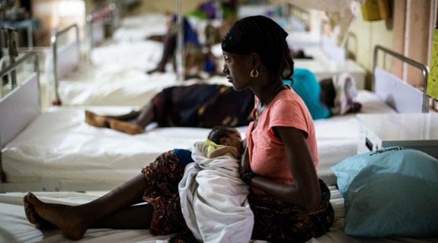 A mother nurses her newborn at the maternity ward of the Kailahun Government hospital in Sierra Leone, hard hit by spread of the Ebola virus/AFP
