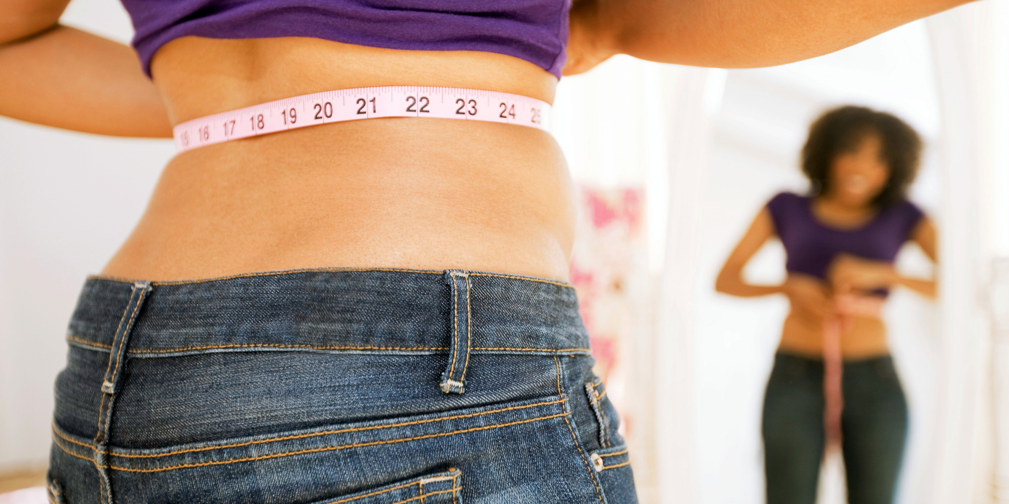 Woman measuring waist