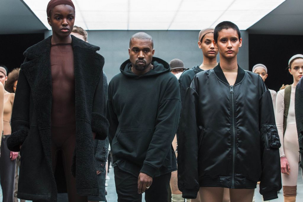 Singer Kanye West walks past models after presenting his Fall/Winter 2015 partnership line with Adidas at New York Fashion Week February 12, 2015. REUTERS/Lucas Jackson (UNITED STATES - Tags: FASHION SOCIETY ENTERTAINMENT)