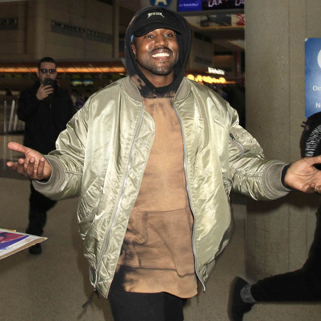 Kanye West is all smiles with arms wide open as he catches a flight out of Los Angeles. The iconic rapper was seen at LAX making his way out of town the day after the 2016 Golden Globe awards. Pictured: Kanye West Ref: SPL1207271 110116 Picture by: Sharky / Splash News Splash News and Pictures Los Angeles: 310-821-2666 New York: 212-619-2666 London: 870-934-2666 photodesk@splashnews.com 