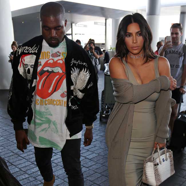 Kim Kardashian and Kanye West arrive at LAX Airport to catch a flight to France