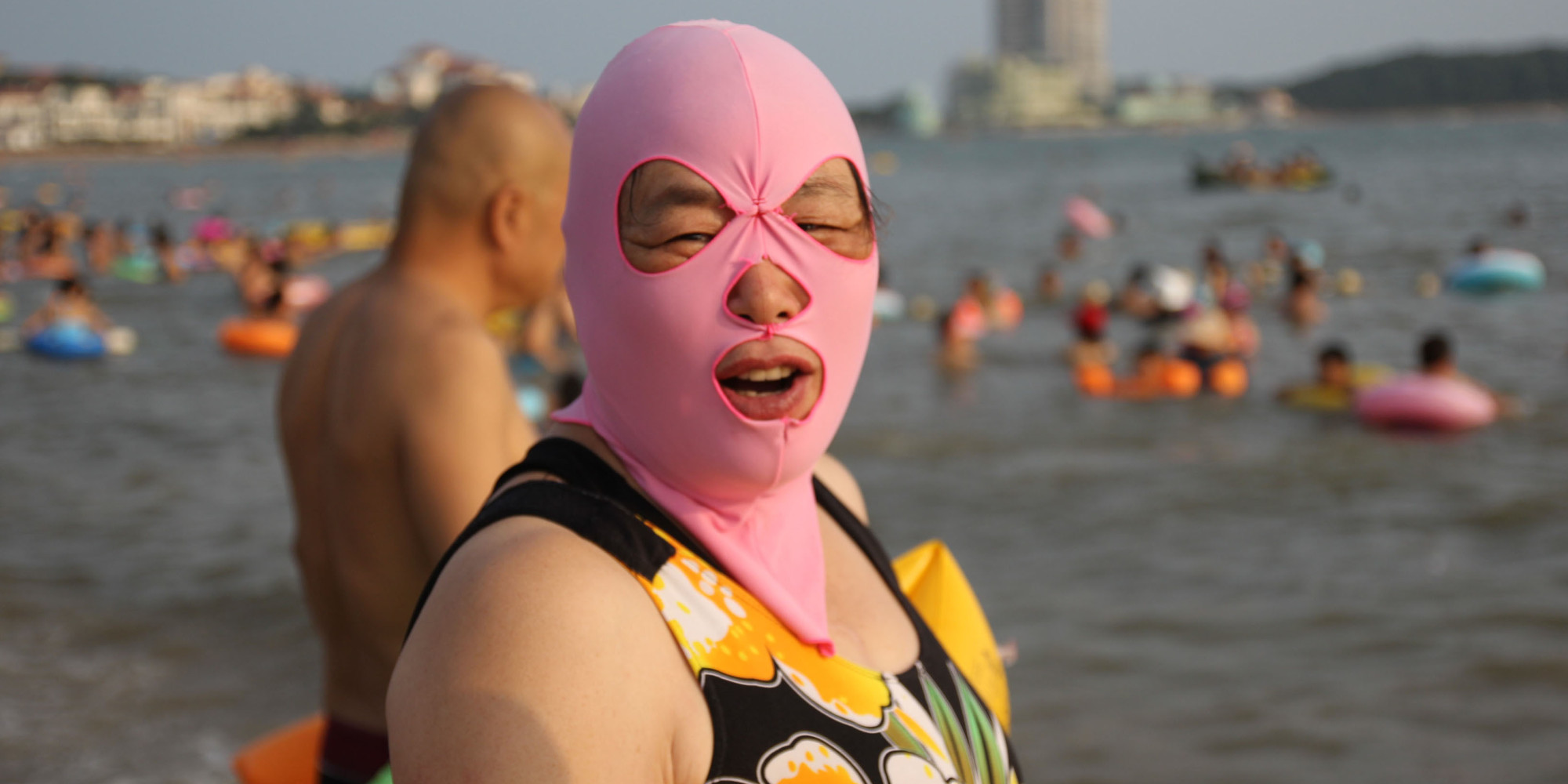 Mandatory Credit: Photo by Imaginechina/REX (4077976h) A woman wearing a facekini Women balaclava style face masks at a beach, Qingdao, Shandong Province, China - 14 Aug 2014 Swimmers in the eastern Chinese city of Qingdao have already made waves on the Internet for their bizarre swimming gear: colorful, full-face masks. Dubbed "facekini," the fabric masks cover a swimmer's entire head and neck down to the collar bones. Holes are cut for eyes, nostrils and mouth. A facekini woman says that the mask not only helps her from getting tanned, it also prevents jellyfish.