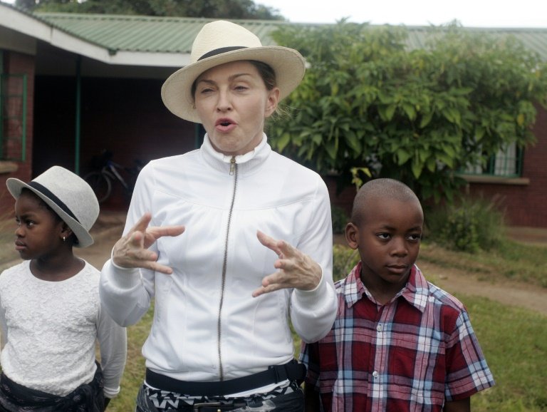 afp-madonna-takes-adopted-children-on-visit-home-to-malawi