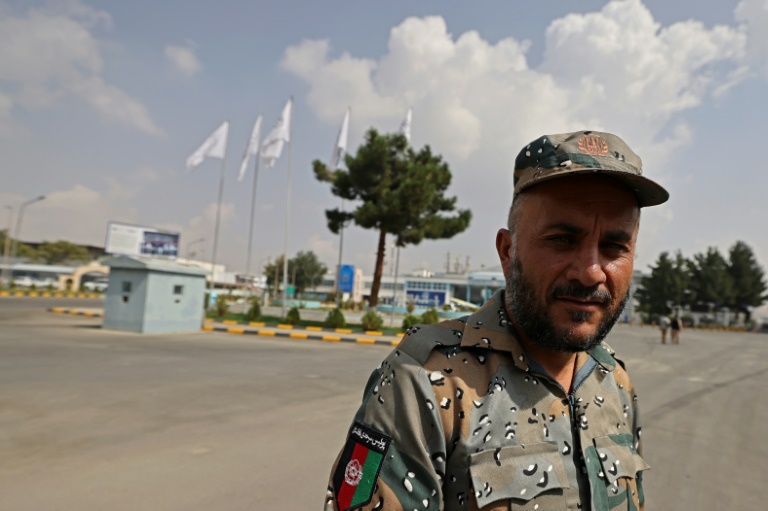 Afghan police return to work alongside Taliban at airport