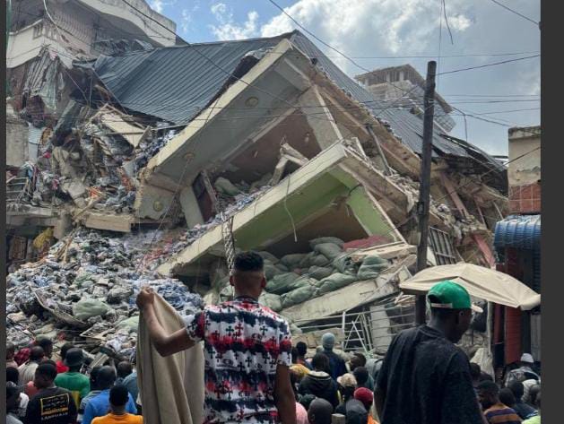Rescuers send water through holes to building collapse trapped