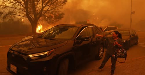 Palisades fire burns homes as thousands evacuate in LA