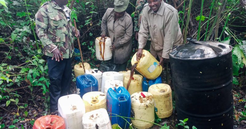 Police destroy 360 litres of illicit liquor in a raid on a hideout along River Chania