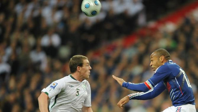 French forward Thierry Henry (R) fights for the ball with Irish defender Richard Dunne during a World Cup 2010 qualifying football match on November 18, 2009 at the Stade de France in Saint-Denis, northern Paris