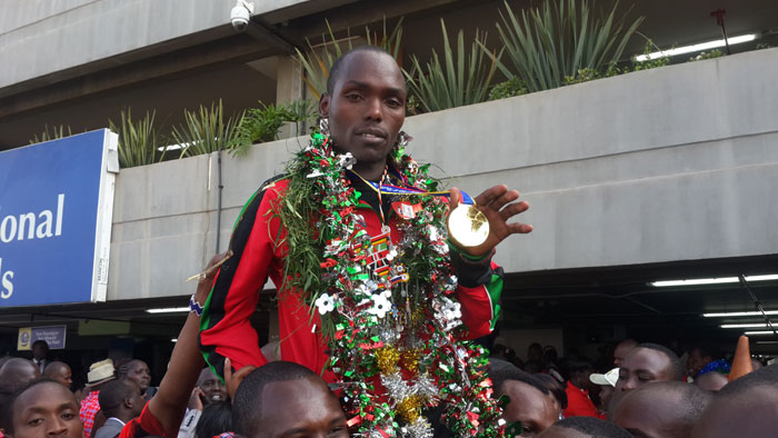 Boys' 1500m gold medallist, Kumari Taki, is hoisted high upon arrival from Cali World Youth. PHOTO/Courtesy