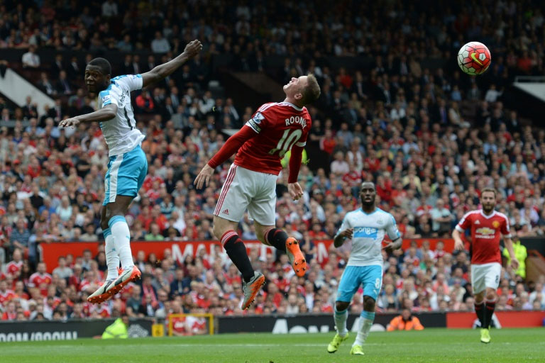 Wayne Rooney jumps for the ball Manchester United's match against Newcastle United at Old Trafford, on August 22, 2015. PHOTO/AFP