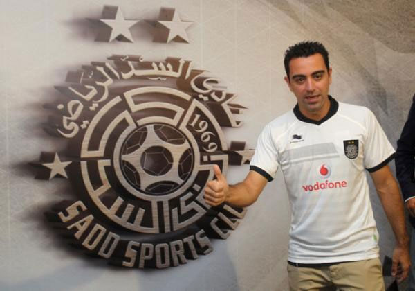 Barcelona legend Xavi Hernandez poses for a photo in his new Al-Sadd club shirt after signing a two-year contract with the Qatari team in Doha on June 11, 2015. PHOTO/AFP