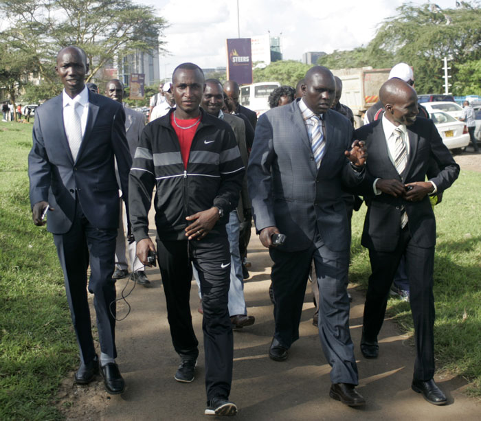 L to R: PAAK officials, Wilson Kipsang (chairman), Julius Ndegwa, Gideon Kiplom (secretary) and Cherangany MP, Wesley Korir match to Nyayo Stadium for talks to end the Riadha House siege on November 24, 2015. PHOTO/Raymond Makhaya