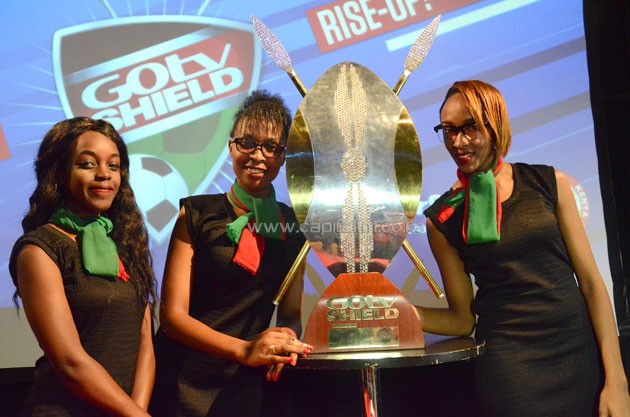 Models Anastacia Njoki, Elizabeth Nduta and Brenda Wacuka pose with the title which will be fought for by 64 teams.PHOTO/Timothy Olobulu.