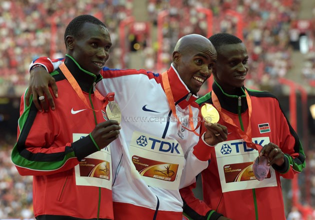 Bedan Karoki and Paul Tanui sandwich winner Mo Farah during the medal ceremony of the 10,000M at the 2015 World Championships in Beijing China. PHOTO/COURTESY